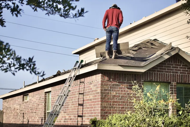 Professional roofer working on a residential roof in Erdenheim